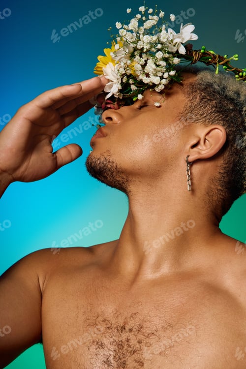 Preview: Muscular young man with dyed hair and flowers posed gracefully in studio setting
