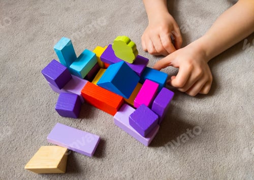 Preview: A child is playing withcolorful heart with colorful wooden building blocks.