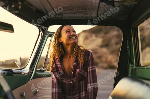 Preview: Happy young woman at pickup truck door at Newport Beach, California, USA