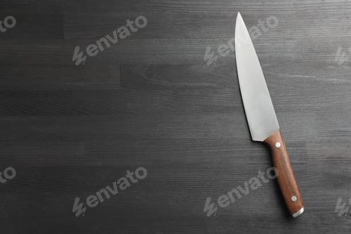 Preview: One sharp knife on black wooden table, top view. Space for text