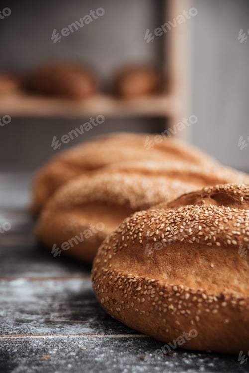 Preview: Bread with flour on dark wooden table