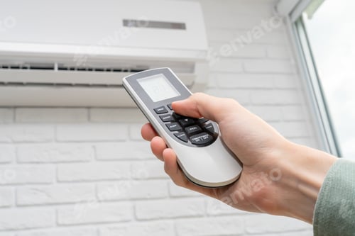 Preview: home air conditioner and man hand with remote control closeup