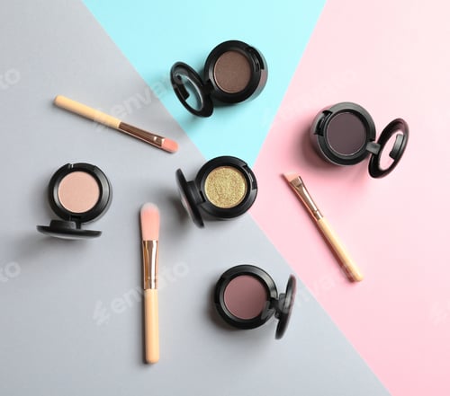 Preview: Flat lay composition with different eye shadows on color background