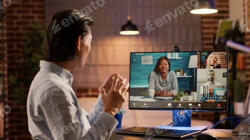 Preview: Asian man attending videocall meeting with group of people