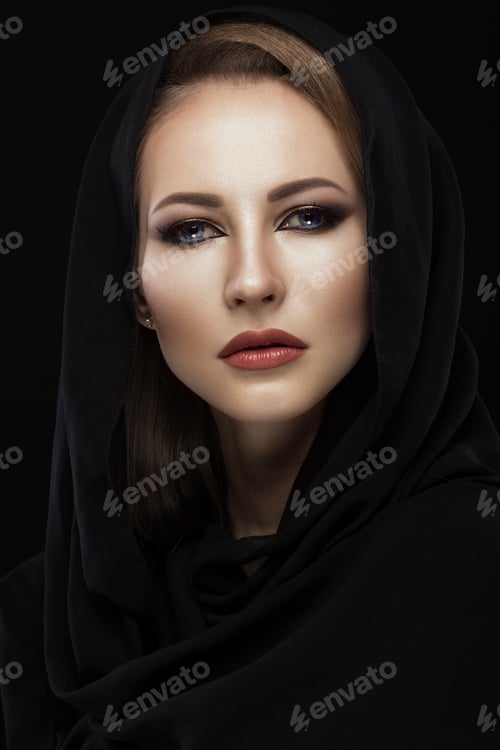 Preview: Beautiful girl in the Arab scarf with oriental make-up. Beauty face.