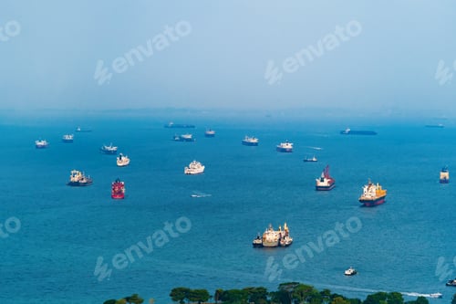 Preview: Cargo tanker ships in transportation concept. Shipping boats at Singapore harbor. Clear blue sea.