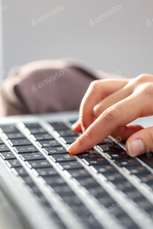 Preview: The girl is typing on the laptop keyboard. Girl's hands on the keyboard.