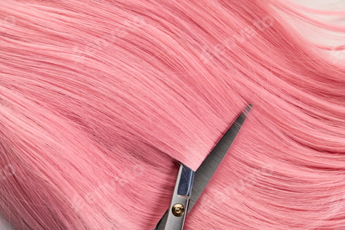 Preview: Top view of scissors and colored pink hair on white background