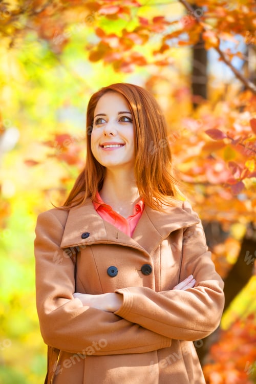 Preview: Redhead girl in autumn park