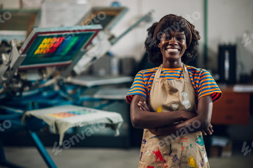 Preview: Portrait of diverse graphic worker at print shop with arms crossed.