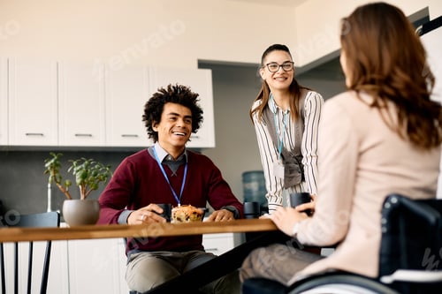 Preview: Group of colleagues enjoying in conversation during their lunch break at work.