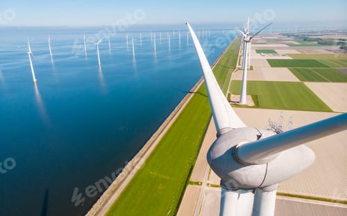 Preview: Windmill turbines at sea seen from a drone aerial view from above at a huge winmill park
