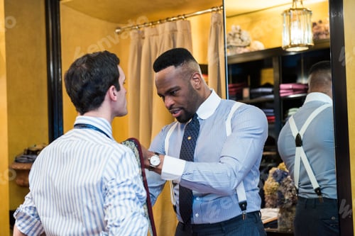 Preview: Tailor fastening customer's tie in tailors shop