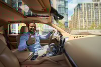 Preview: Motorist seated in his car cabin showing gesture of approval