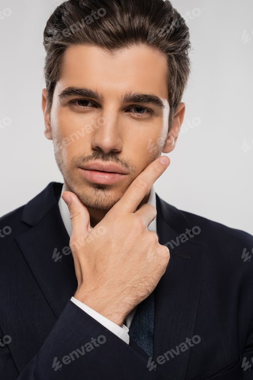 Preview: portrait of good looking businessman in formal wear looking at camera isolated on grey