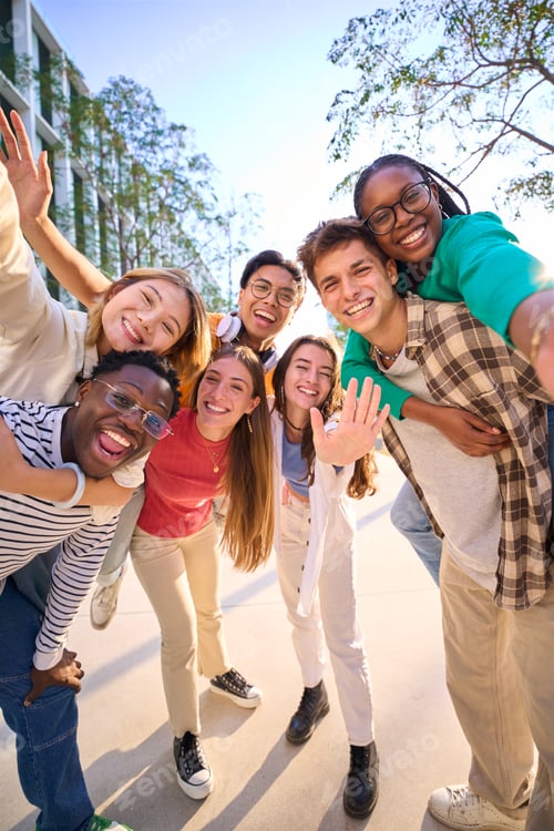 Preview: A large multiracial group of teenagers taking a selfie looking front camera laughing
