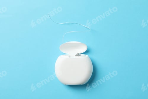 Preview: Dental floss on blue background, space for text