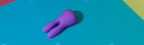 Preview: Violet dildo vibrator for clitoris on colored background with contrast shadows. Sex toy for adult