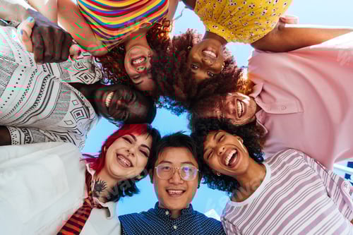 Preview: Multiethnic group of young friends meeting and having fun outdoors