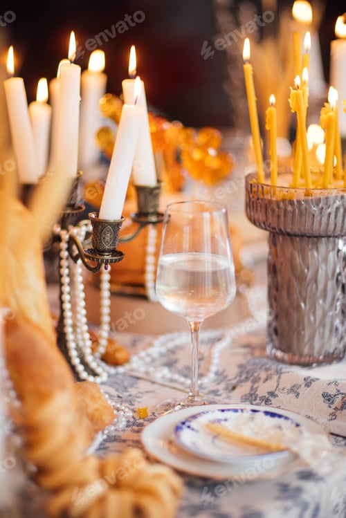 Preview: Elegant dining table set for a festive occasion with lit candles