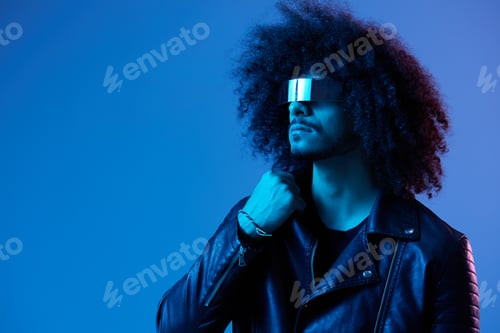 Preview: Portrait of fashion man with curly hair with stylish glasses on blue background multinational