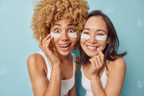 Preview: Pretty two female friends use undereye skin beauty masks prevent bags reduce facial puffiness enjoy