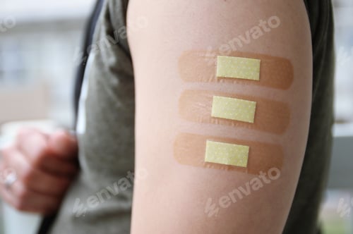 Preview: Three band aids on arm.