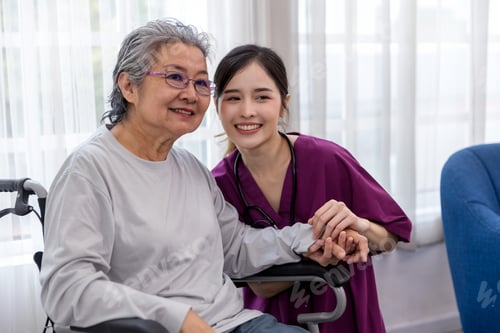 Preview: Caregiver nurse take care a Senior patient sit on wheelchair. Nurse helping senior Woman