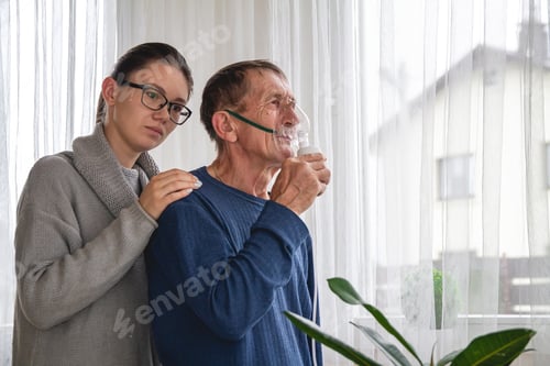 Preview: Young woman and elderly senior with oxygen mask in quarantine at