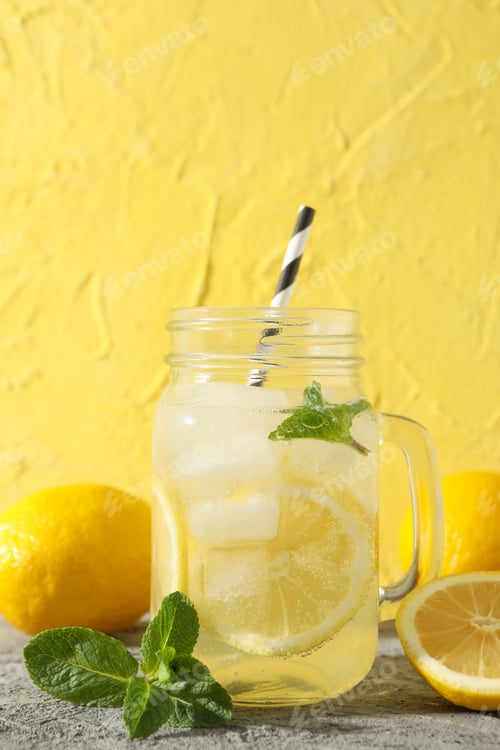 Preview: Lemonade, lemons and mint on grey table. Fresh drink
