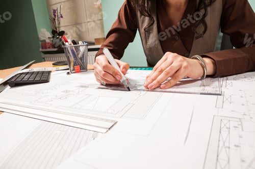 Preview: Close up of architect hands working on blueprints