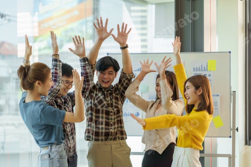 Preview: Successful group of young Asian business people achieving goals excited raised hands rejoicing.