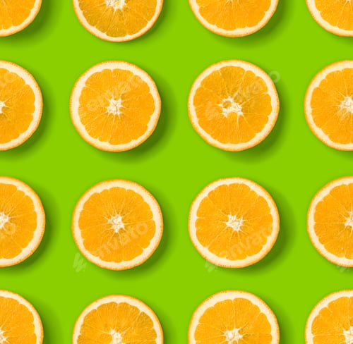 Preview: Fruit pattern of orange slices on green background. Flat lay, top view. Food background.