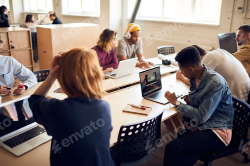 Preview: Skilled male and female bloggers connecting to coworking internet for browsing information