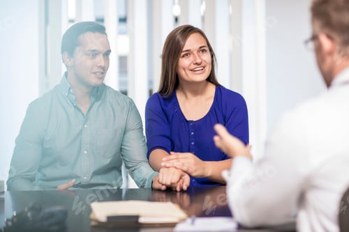 Preview: Doctor talking to couple in medical practice