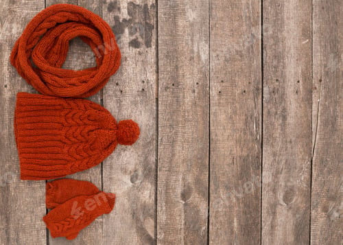 Preview: Warm knitted accessories arranged on wooden surface for winter season preparation