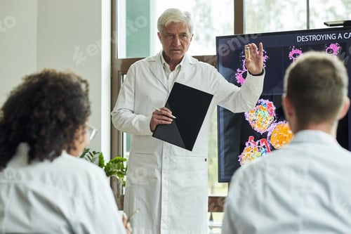 Preview: Senior Caucasian Man Explaining Cancer Research Results to Diverse Scientists