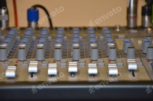 Preview: Professional audio mixing console with faders and adjusting knobs and xlr connectors.