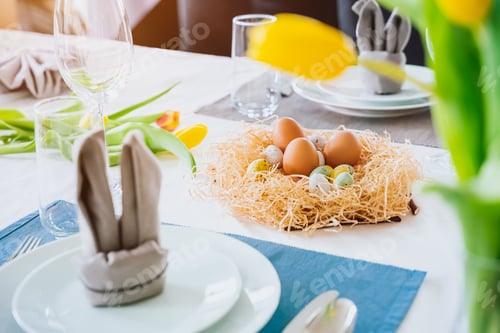 Preview: Beautiful Easter table setting with festive decor indoors,colorful eggs