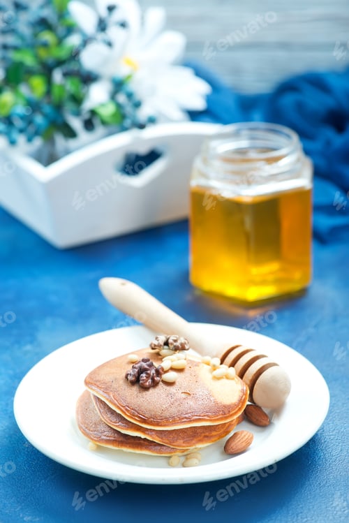Pancakes with Honey and Nuts on Tabletop