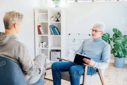 Preview: Professional psychotherapy. Male psychologist having session with patient at mental health clinic,