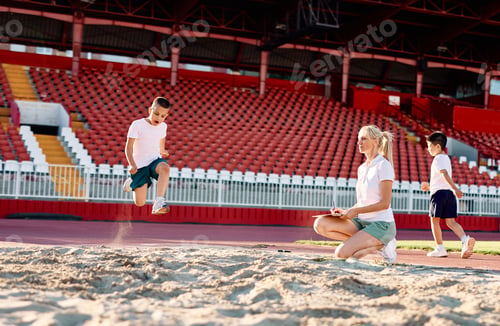 Preview: Children having sport exercise training class outdoors