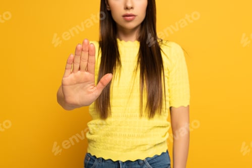 Preview: Cropped view of woman showing no sign on yellow background