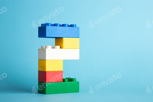 Preview: Color plastic building blocks on blue background