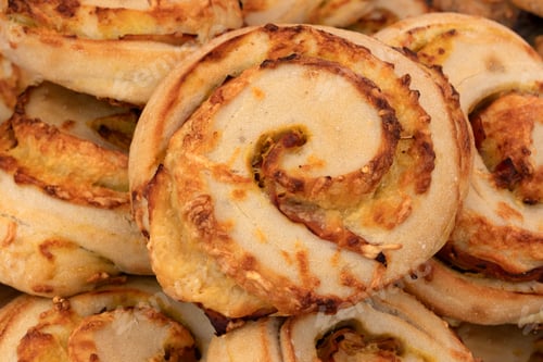 Preview: Fresh baked cheese buns of bread close up full frame