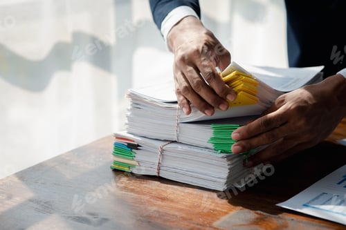 Preview: Businessman working, businessman looking at business documents and checking company finances, young