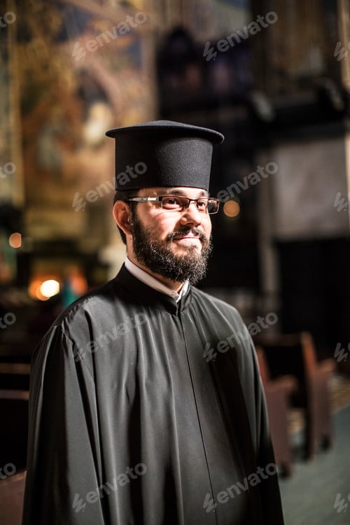 Preview: Priest with a serene gaze standing inside a church.