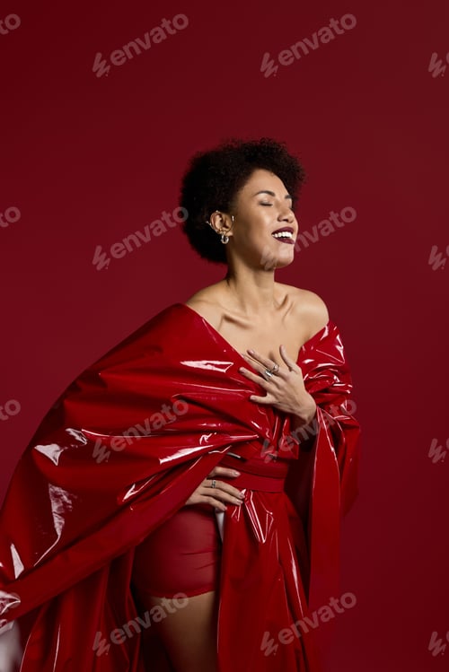Preview: Young beautiful woman exudes confidence in stylish red attire against a striking backdrop
