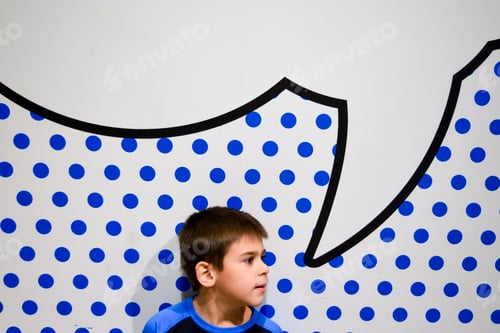 Preview: Boy in front of a polkadot blue background and a speech bubble
