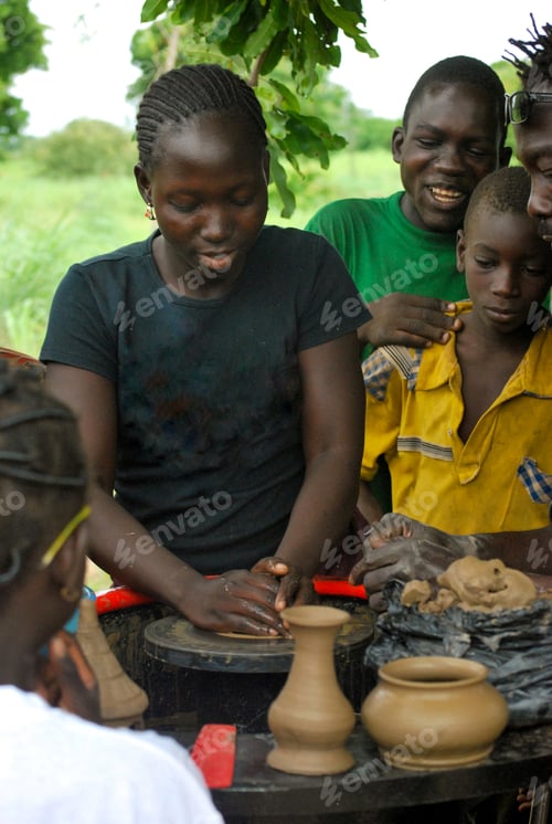 Preview: Young african streeft child ( girl) taking a pottery course - reeducation volunteering